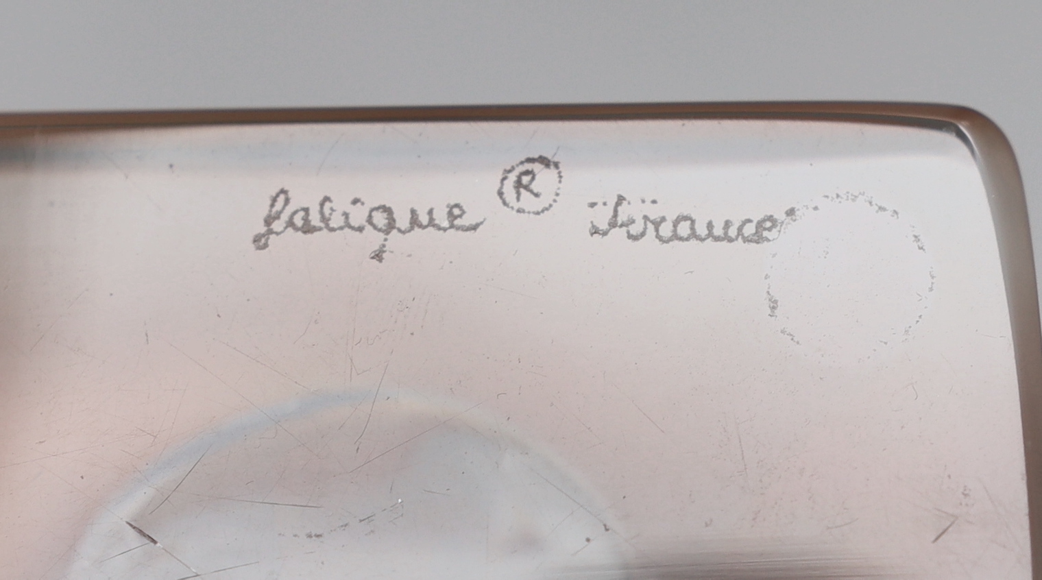 A Lalique Hirondelle bookend and two dishes with leaf design to rims, swallow height 15.8cm (3)